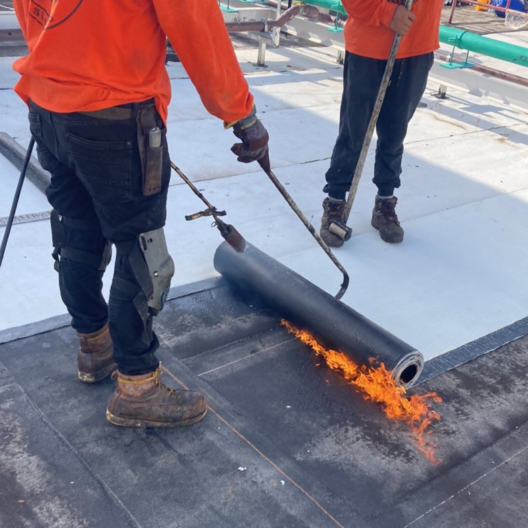 modified bitumin roofing being installed