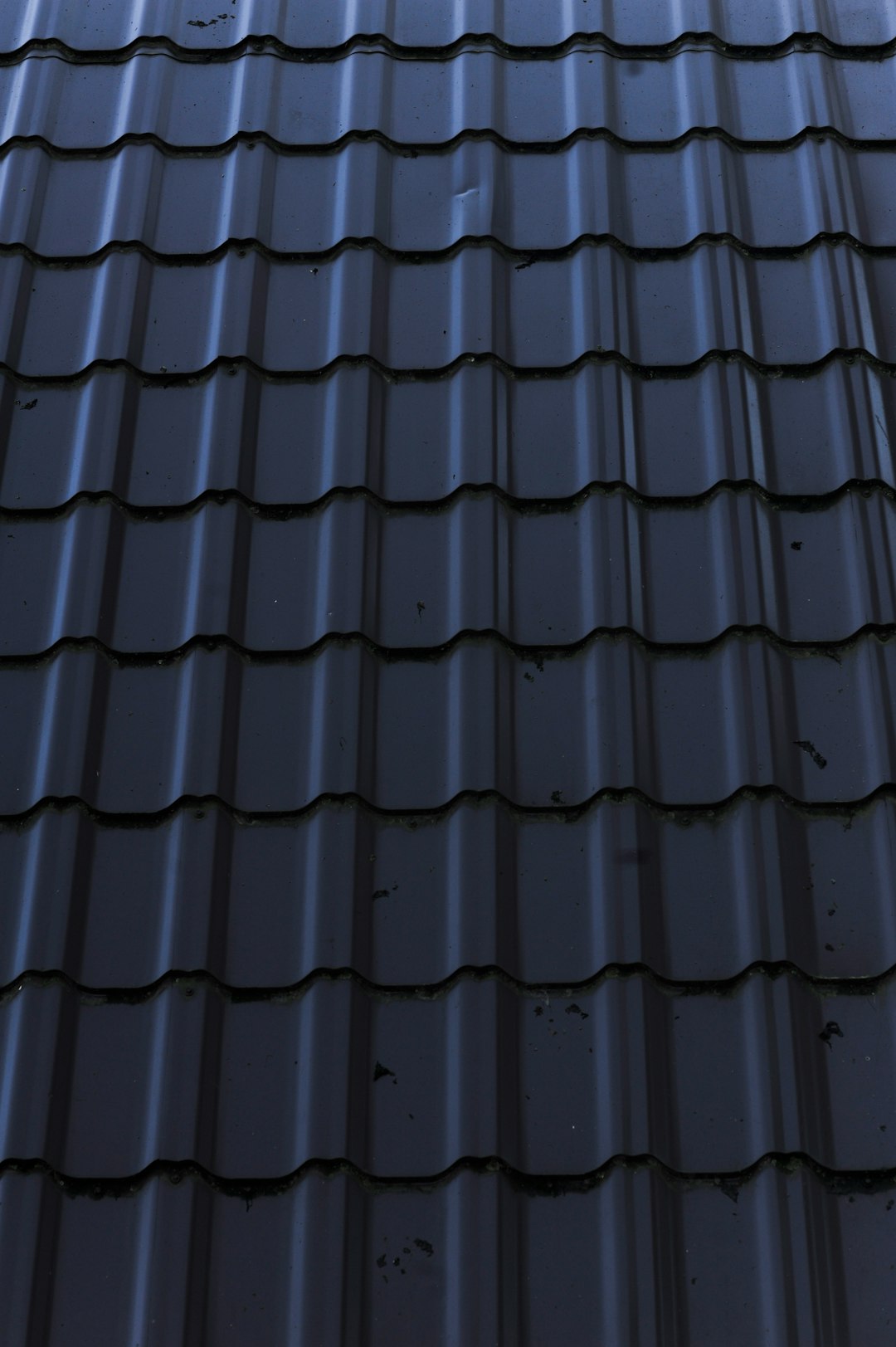 a close up of a metal roof with a sky background