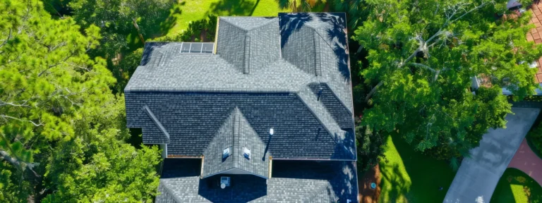 a professional roofer inspecting and repairing a sturdy, well-maintained roof on a sunny day in jacksonville.